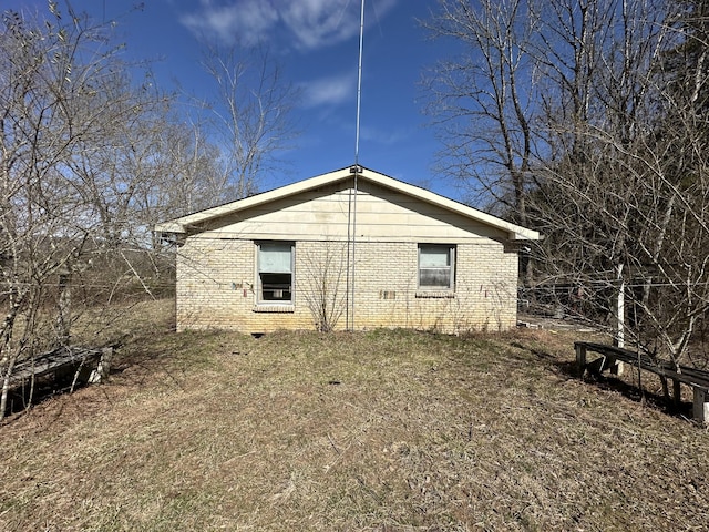 view of side of home featuring brick siding