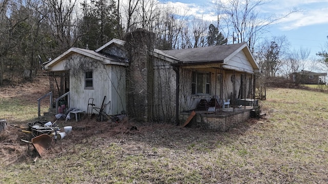 view of side of home featuring brick siding and a chimney