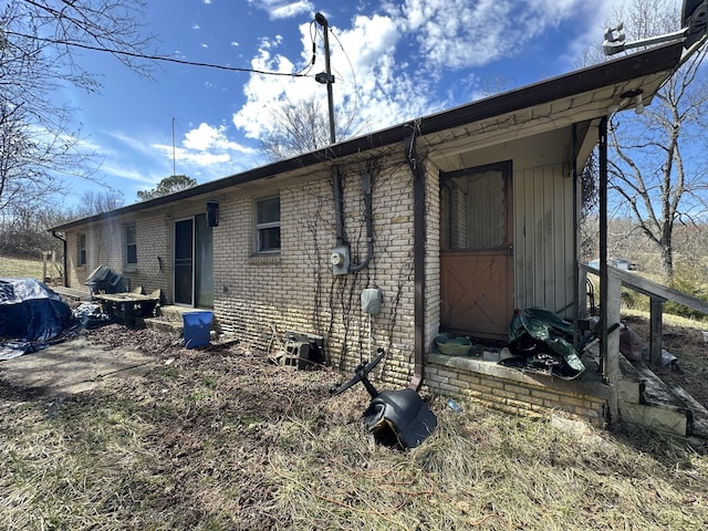 rear view of house with brick siding