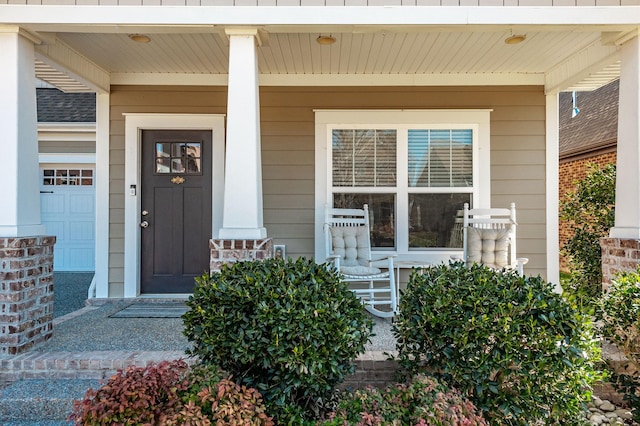 view of exterior entry with covered porch