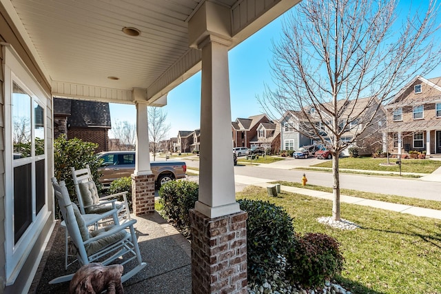 view of patio with a residential view and a porch