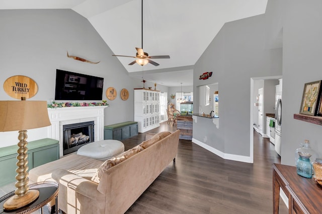 living room with a fireplace, dark wood-type flooring, ceiling fan, high vaulted ceiling, and baseboards