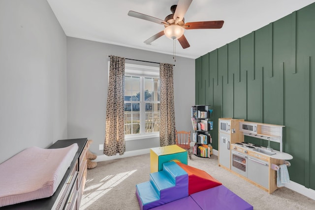 playroom featuring ceiling fan, carpet flooring, and baseboards