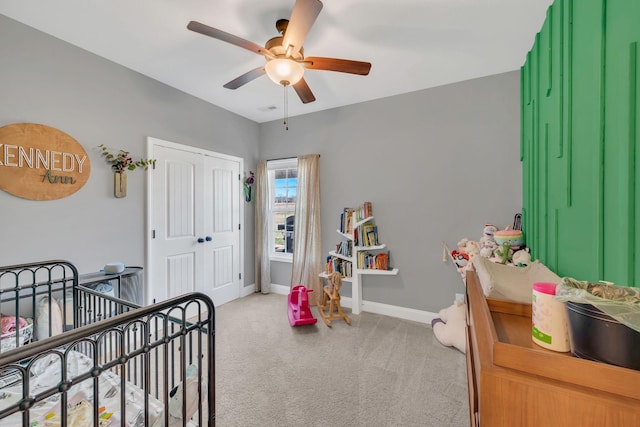 bedroom featuring a closet, light carpet, ceiling fan, and baseboards