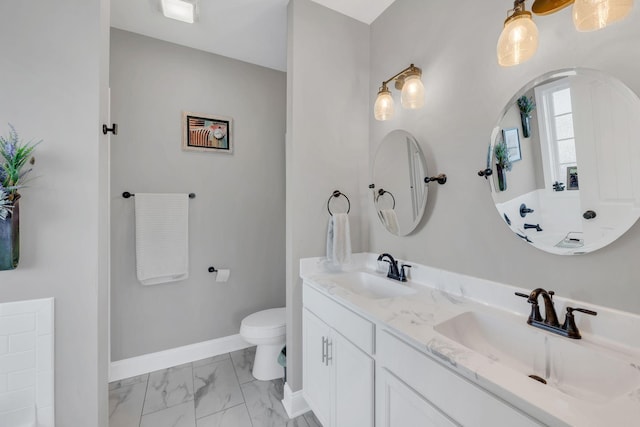 full bath featuring marble finish floor, a sink, baseboards, and toilet