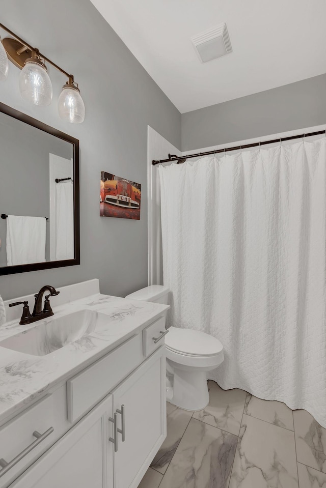 bathroom featuring toilet, marble finish floor, visible vents, and vanity