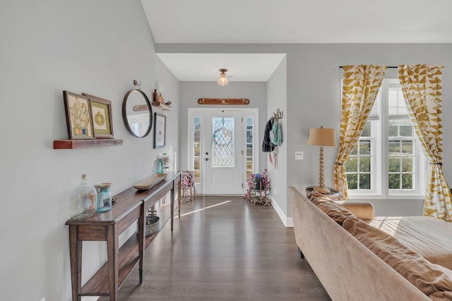 entryway with dark wood-style floors and baseboards