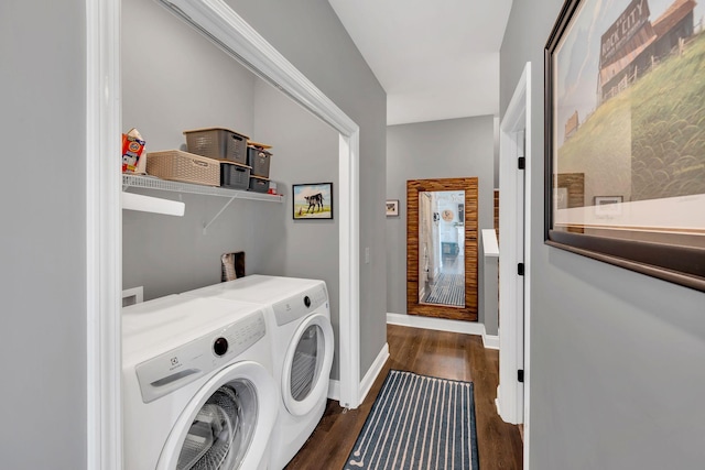 clothes washing area with laundry area, dark wood-type flooring, separate washer and dryer, and baseboards