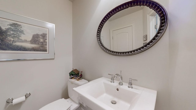 bathroom featuring a sink and toilet