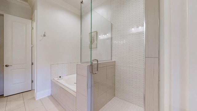 full bath with a garden tub, a shower stall, tile patterned flooring, and crown molding