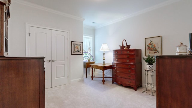 bedroom with a closet, light carpet, crown molding, and baseboards