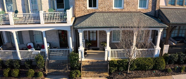 view of front of home with covered porch and brick siding