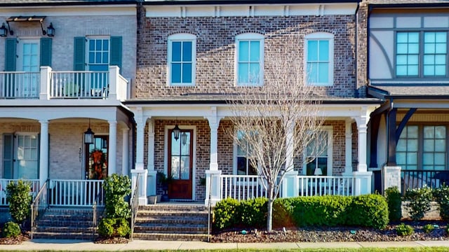 view of front facade featuring a porch and brick siding