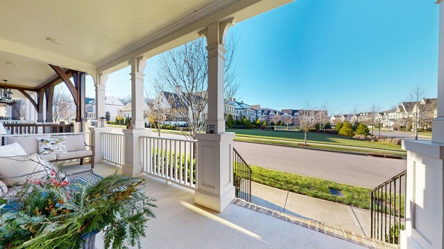 view of patio / terrace featuring a porch and a residential view