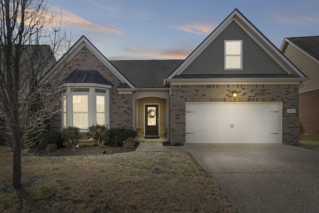 view of front facade featuring a garage, concrete driveway, and brick siding