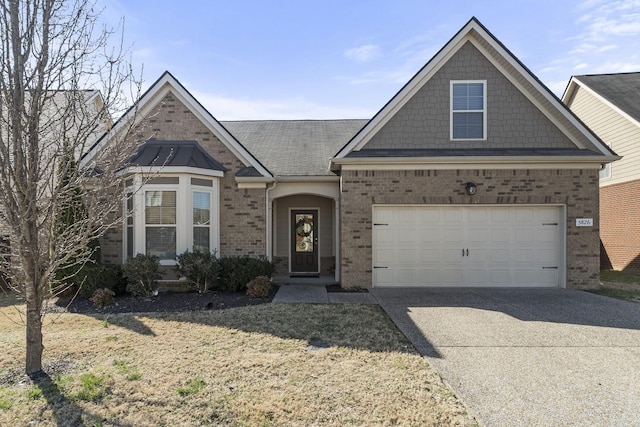 view of front of house featuring a garage, a front yard, concrete driveway, and brick siding