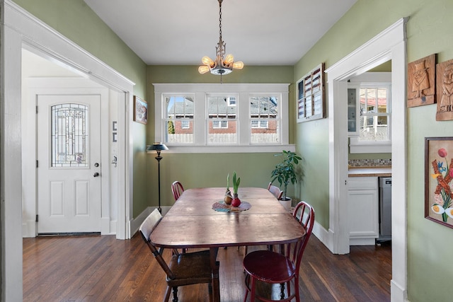 dining room featuring baseboards, a chandelier, and dark wood-style flooring