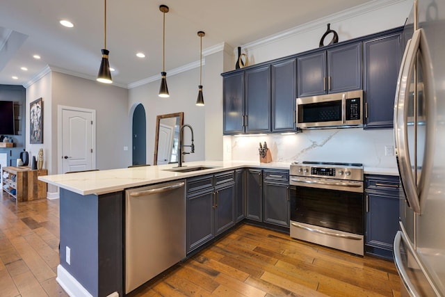 305 Seven Springs Way Unit 401, Brentwood, TN 37027 - kitchen with arched walkways, a peninsula, dark wood-type flooring, a sink, and appliances with stainless steel finishes