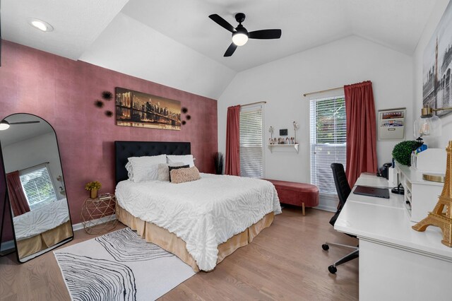 bedroom with lofted ceiling, ceiling fan, baseboards, and wood finished floors