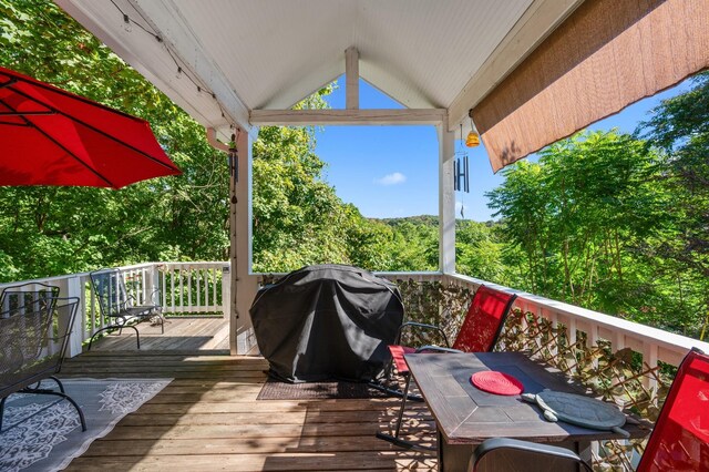 wooden deck featuring a grill