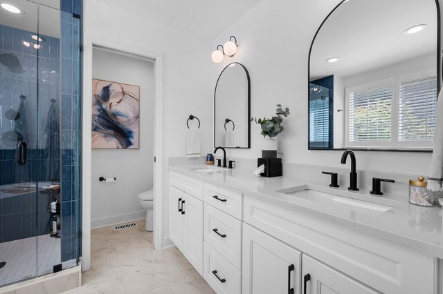 full bath with toilet, marble finish floor, a sink, and visible vents