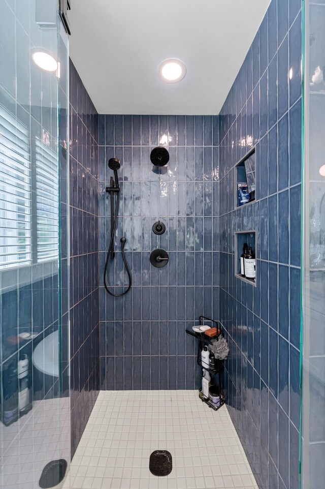 bathroom with tiled shower