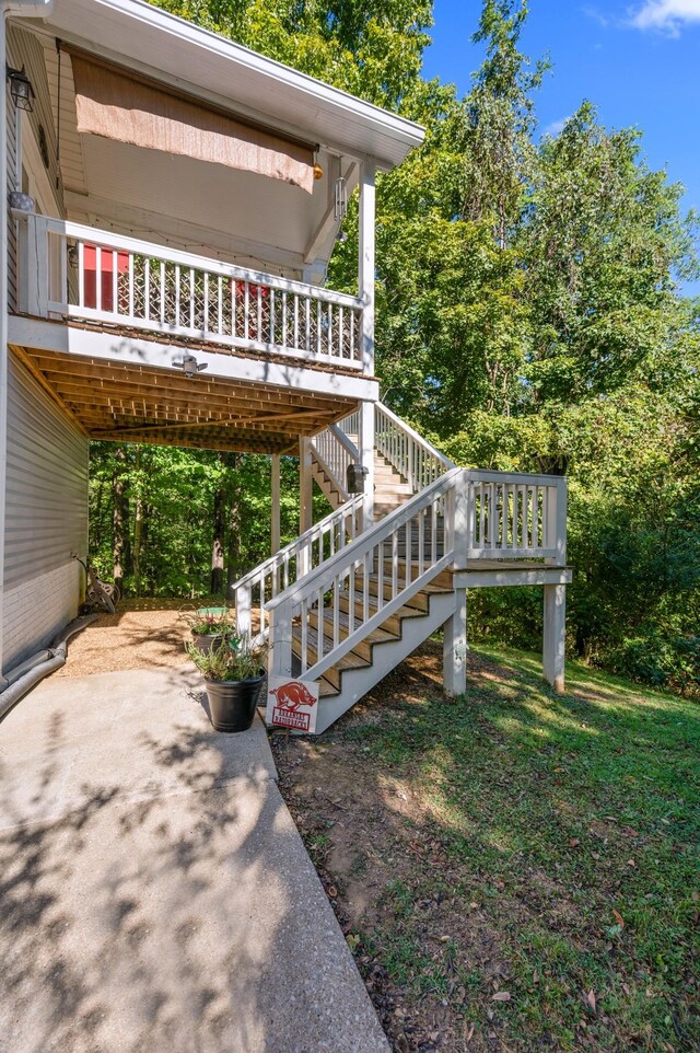 view of home's exterior with stairs and a carport