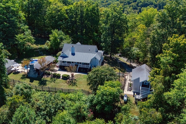 birds eye view of property with a wooded view