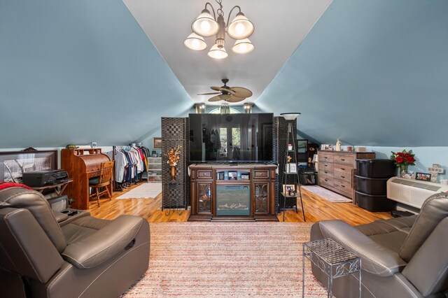 living room featuring ceiling fan, vaulted ceiling, and wood finished floors