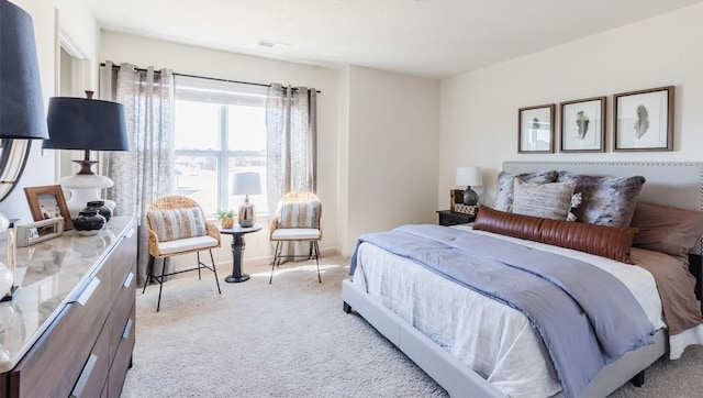 bedroom with light carpet and visible vents