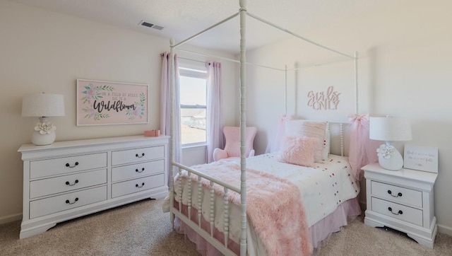 bedroom with baseboards, visible vents, and light colored carpet