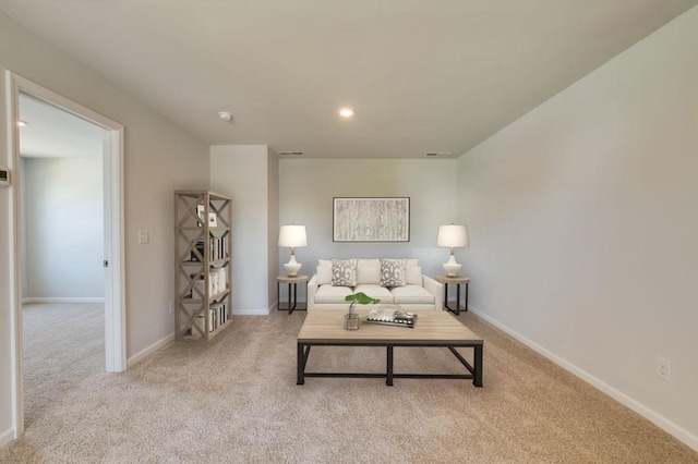 carpeted living area with recessed lighting, visible vents, and baseboards