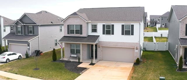 view of front of home featuring an attached garage, brick siding, driveway, a residential view, and a gate