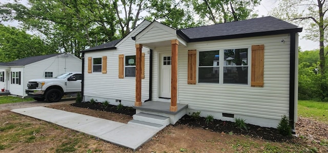 bungalow-style home with crawl space and roof with shingles