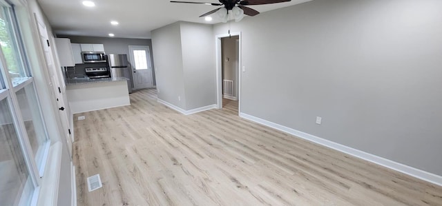 interior space featuring recessed lighting, visible vents, ceiling fan, light wood-type flooring, and baseboards