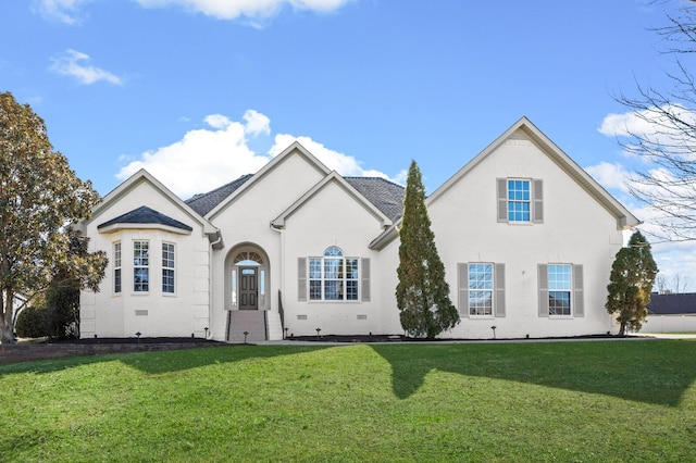 view of front facade with a front yard, crawl space, and brick siding