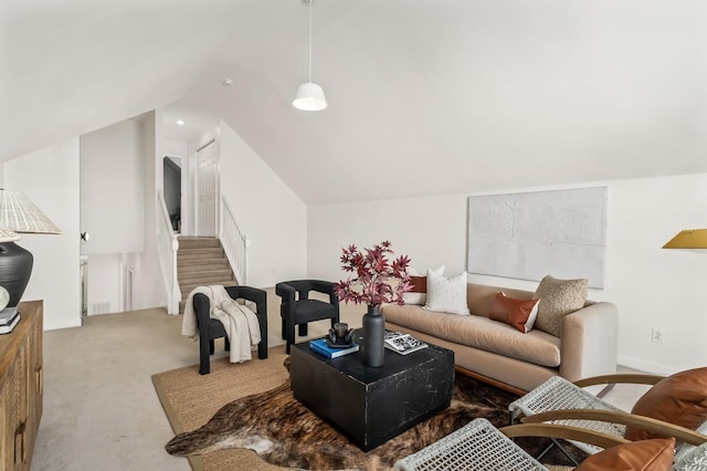 carpeted living area featuring lofted ceiling and stairway