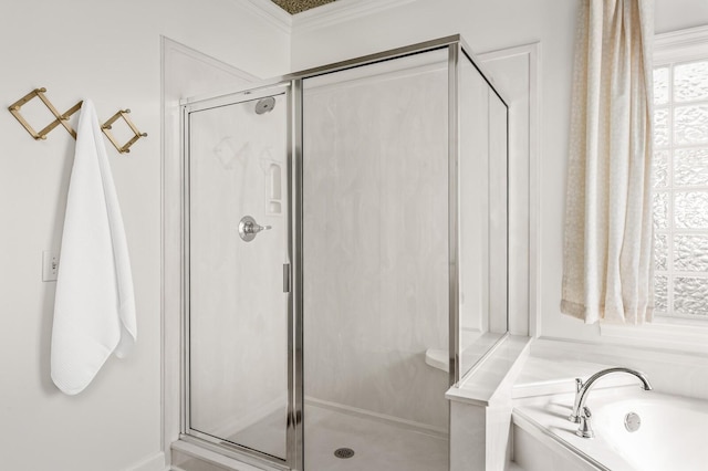 bathroom featuring a stall shower, crown molding, and a bath