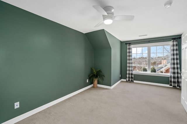 bonus room featuring carpet, baseboards, vaulted ceiling, and a ceiling fan