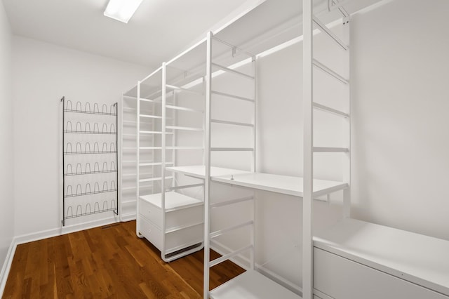 walk in closet featuring dark wood-type flooring