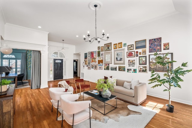 living room featuring baseboards, wood finished floors, and crown molding