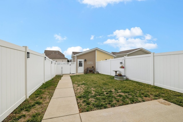 view of yard featuring a gate and a fenced backyard