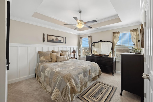 bedroom featuring light carpet, multiple windows, visible vents, and a raised ceiling