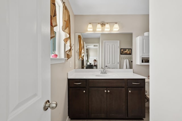 bathroom with toilet and vanity