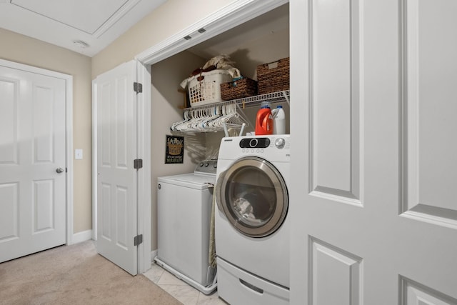 laundry room featuring baseboards, laundry area, light carpet, and washer and dryer