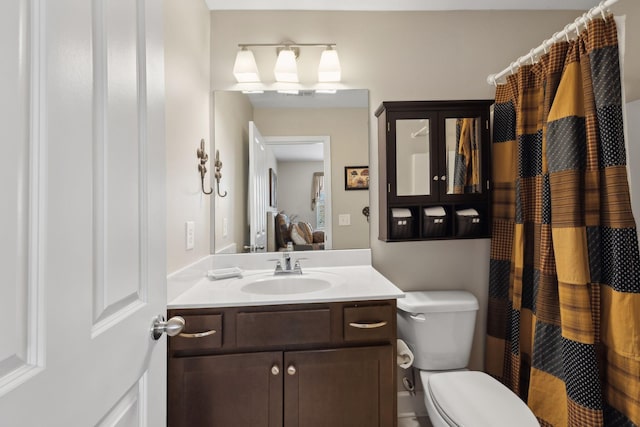 bathroom with toilet, a shower with curtain, and vanity