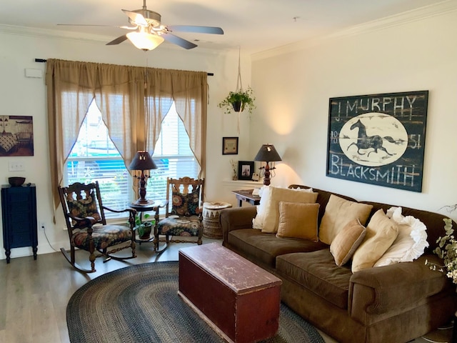 living area with ceiling fan, wood finished floors, and crown molding