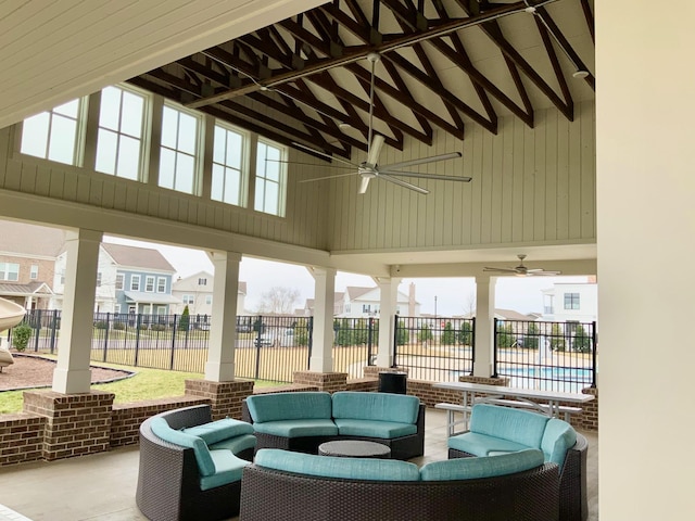 view of patio / terrace featuring ceiling fan, a residential view, fence, and an outdoor living space