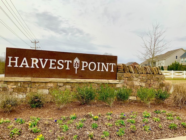 community / neighborhood sign with fence