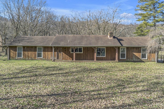 single story home with a front yard and a chimney